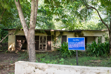 sign board in beatles ashram,rishikesh with abandoned building