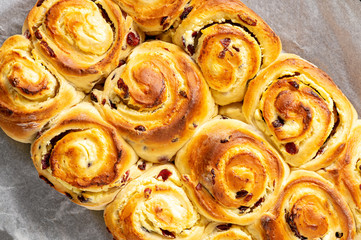 Homemade sweet bread buns with cottage cheese and cranberries filling.