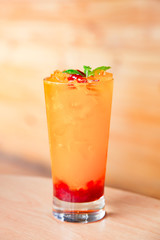 Fresh orange juice soda with strawberry syrup