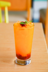Fresh orange juice soda with strawberry syrup