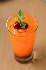 Fresh orange juice soda with strawberry syrup