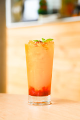 Fresh orange juice soda with strawberry syrup