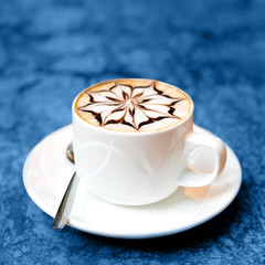 Cappuccino cup on marble background, toned in blue. Square