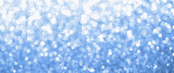 Classic blue 19-4052 color blurred glitter background. Sparkling and shiny texture for Christmas and New Year holiday or seasonal wallpaper decoration