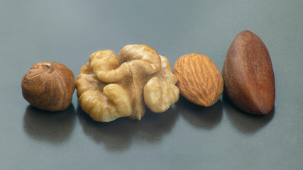 different nuts close-up on a gray background. Healthy food and vitamins