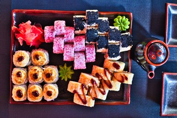 Christmas sushi food on black plate with teapot