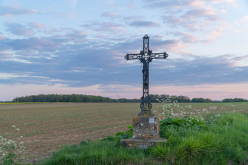 Fototapeta na wymiar Calvary near a field in the countryside, Vexin, France