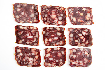 sliced ​​parts of sausage, salami on a white background. fast food and breakfast