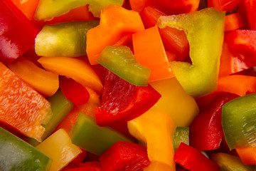 Sliced ​​colored bell peppers on a plate. Vitamin healthy food.