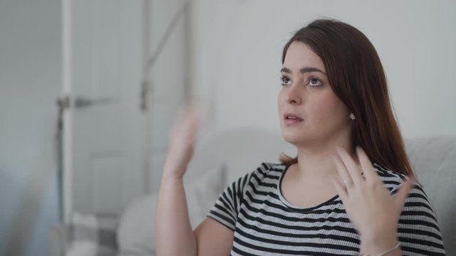 Woman with heat fanning herself with her hands.