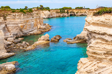 Torre Sant Andrea beach with its soft calcareous rocks and cliffs, sea stacks, small coves and the...