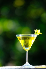 glasses of cocktails on green background