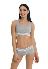Beautiful young woman in grey sportive underwear isolated on white