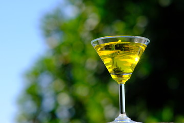 glass of cocktail on green background