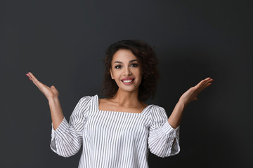 Emotional woman in casual outfit on black background