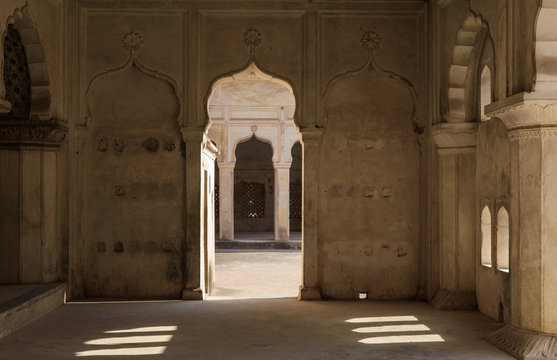 Orchha, Madhya Pradesh/India - March 14 2019: Play of light and shadow with the arched doorways, windows and architectural detail of the ancient Raja Mahal.