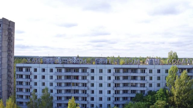 Aerial view of house labeled "&rsquo;ай буде атом робiтником, а не солдатом" in Pripyat town. Aerial shooting abandoned architecture of ghost city