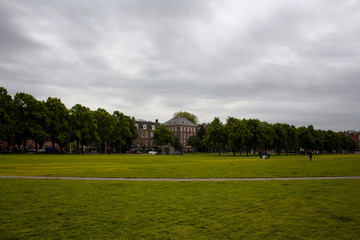 View of people hanging out at Museum Quarter (square) in Amsterdam. It is a summer day with cloudy sky.