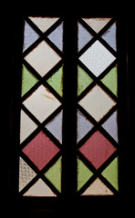 Colorful beautiful glass closed window on a old building. stained glass window of colored glass