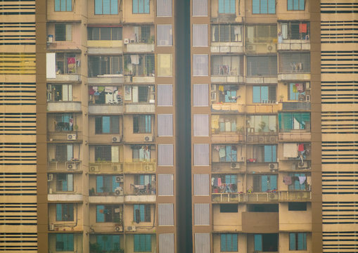 The geometric, rectangular patterns of the exterior facade of a skyscraper with apartment blocks in the suburb of Kandivali East. in Mumbai