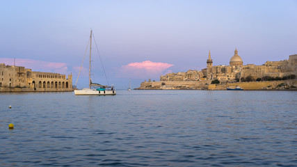 Malta. Valletta skyline at sunset with Basilica and Lazzaretto of Manoel Island, viewed from Ta Xbiex