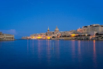 Malta. Valletta skyline at sunset with Basilica and Lazzaretto of Manoel Island, viewed from Ta Xbiex