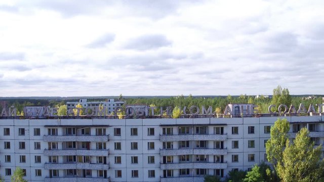 Aerial view of house labeled "&rsquo;ай буде атом робiтником, а не солдатом" in Pripyat town. Aerial shooting abandoned architecture of ghost city