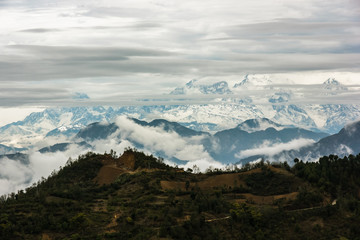 A view of the clouds hanging over the Annapurna range across the hills from the outskirts of the town of Tansen in Nepal.