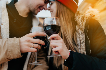 couple at the christmas market drink wine. man and woman in red hat