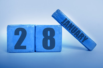 january 28th. Day 28 of month, Handmade wood cube calendar with date month and day in trendy classic blue color of the year winter month, day of the year concept