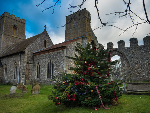Christmas tree near the ancient All Saints Church, Weybourne, Norfolk, England, UK
