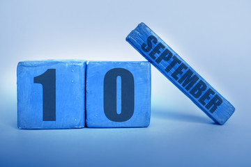 september 10th. Day 10 of month, Handmade wood cube calendar with date month and day in trendy classic blue color of the year autumn month, day of the year concept