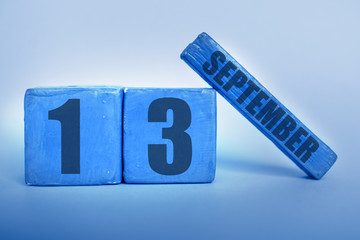 september 13th. Day 13 of month, Handmade wood cube calendar with date month and day in trendy classic blue color of the year autumn month, day of the year concept
