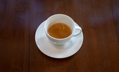 Cup of coffee on an old wooden table