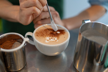 morning coffee. teddy bear latte art made with milk foam.cup of coffee on wooden table