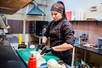 the Cook woman prepares food sushi restaurant kitchen