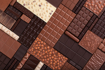 varied chocolate background. milk and dark cocoa bar, top view.