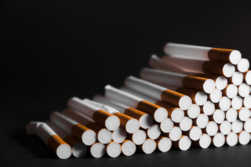 lots of cigarettes on a black background