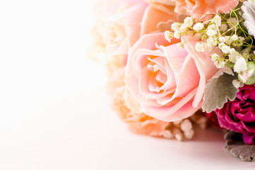 beautiful closeup rose bouquet containing pink rose flowers and leaves and branch of gypsophila for decoration