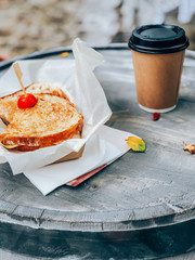 Sandwich on paper with coffee. Street food concept