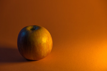 green Apple on orange background