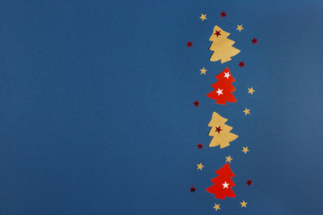 Christmas banner with Xmas tree and stars handmade on blue background with copy space. Flat lay.