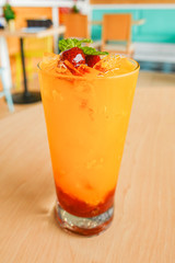 Fresh orange juice soda with strawberry syrup