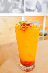 Fresh orange juice soda with strawberry syrup