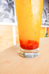 Fresh orange juice soda with strawberry syrup