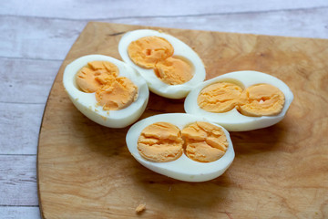 Boiled eggs in a bowl decorated with parsley leaves