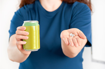 woman hands holding a soda drink can and saccharin