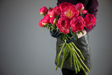 Beautiful bouquet of dark pink peony. The work of the florist. Flower delivery