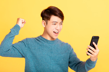  excited young man looking at mobile phone