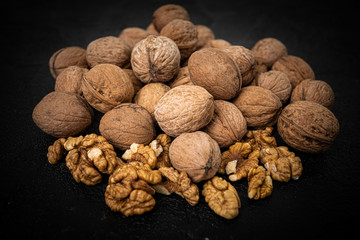 Lot of whole ripe brown walnut  on black